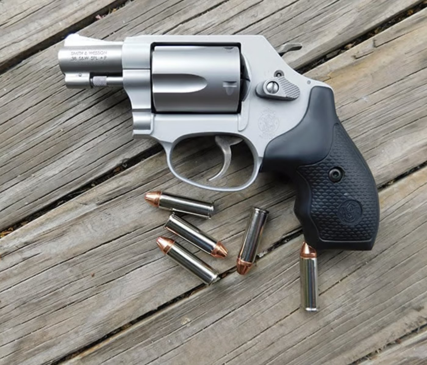 S&W Airweight with cartridges on wood